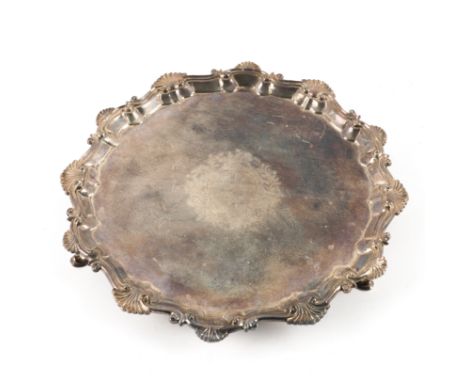 A LATE GEORGE II SILVER SALVEROf shaped circular form, having a Chippendale style shell and piecrust rim, armorial engraved t