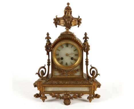 A FRENCH LOUIS XVI STYLE GILT-METAL AND WHITE ONYX MOUNTED MANTEL CLOCKLate 19th Century 
The case surmounted by an urn, Roma