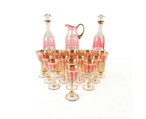 A CONTINENTAL GLASS PART TABLE SERVICE ( 18)Probably Moser, 20th century Each piece with gilt foliate borders around cranberr