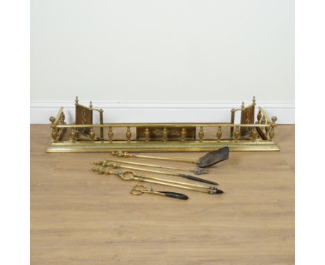 TWO EDWARDIAN BRASS HEARTH FENDERS AND BRASS FIRE TOOLS  (7)Early 20th Century 
The rectangular fender with baluster gallery,