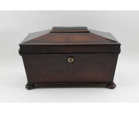 A William IV rosewood double tea caddy of sarcophagus form, the hinged cover with mother-of-pearl inlay, opens to reveal two 