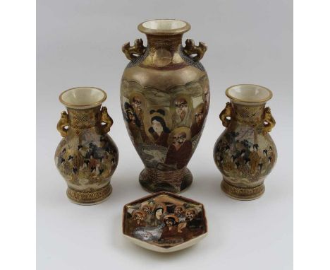 A pair of Japanese Satsuma ceramic vases, of baluster form, having gilded handles, painted with figures in landscape decorati