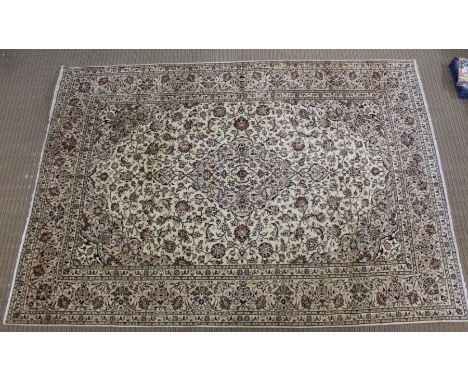 A Persian Kashan woven woollen carpet, floral design field on pale ground, 350cm x 245cm