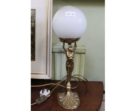 A modern brass table lamp of female form holding aloft a globe,&nbsp;A few rough areas to brass casting, it is externally wir