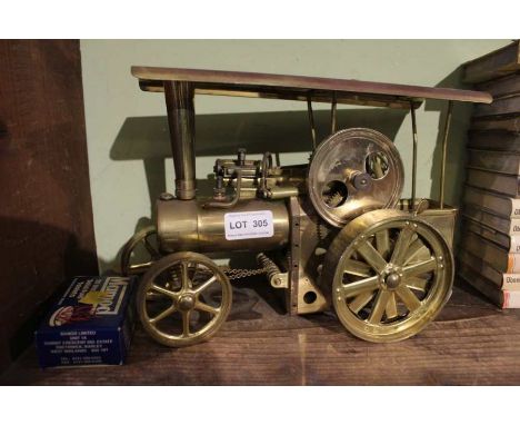 A Wilesco brass finished live steam traction engine, the canopy length is 27cm x 10cm, height of maching is 19.5cm
