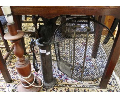 A fireguard, companion set and a wooden lamp