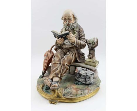 A Capodimonte ceramic figure, a tramp reading, 24cm&nbsp;