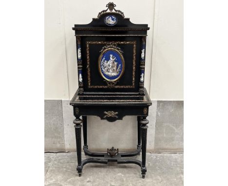 A Napoleon III ebonised and ormolu mounted lady"s bonheur du jour, third quarter 19th Century, shaped cresting above a door m