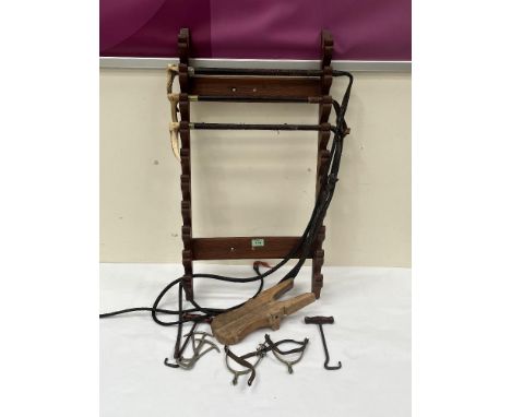 Three hunting whips, a pine whip rack, boot jack and a pair of spurs.