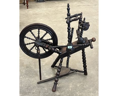 A 19th Century oak bobbin turned spinning wheel with wool winders. 35" high.