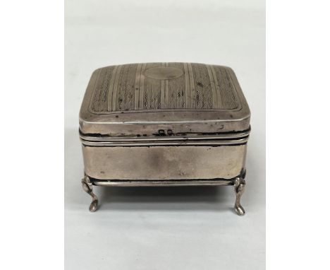 A George V silver trinket box with engine turned lid, the interior silk lined. Birmingham 1911. 3½" wide. 6ozs gross.