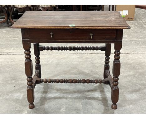 A William III and later joined oak side table with frieze drawer, on bobbin turned and square supports and stretchers. Front 