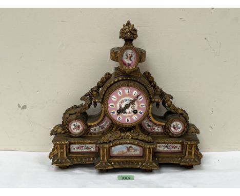 A 19th Century French gilt metal mantle clock mounted with foliate swags and inset porcelain plaques painted with flowers and