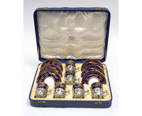 An Edwardian silver mounted set of six Crown Staffordshire "Egg Shell" pattern coffee cans and saucers, cobalt blue ground wi