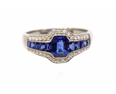 An Art Deco style sapphire and diamond platinum set ring, comprising a central octagonal cut sapphire approx 5.9 x 4.8mm, wit