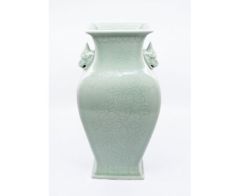 A large Light Green stoneware Chinese vase depicting an engraved decoration of flowers and leaves, with faux dogs to sides, c