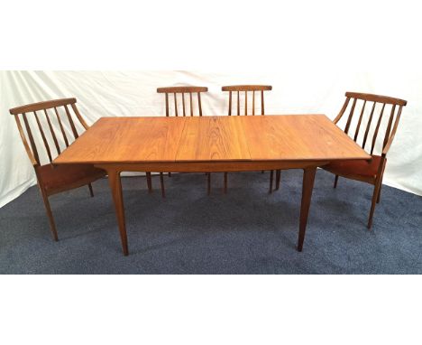 MID-CENTIRY TEAK EXTENDING DINING TABLE AND FOUR CHAIRSthe table with a rectangular pull apart top revealing a fold out leaf,