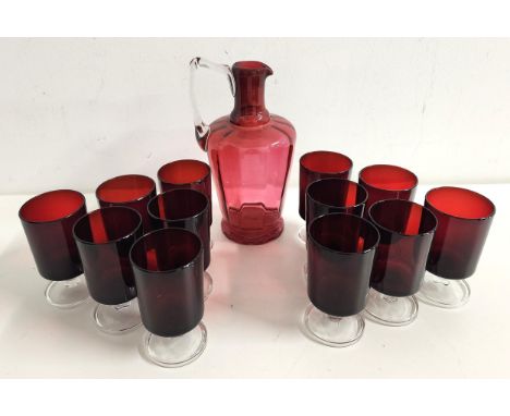 SET OF TWELVE FRENCH WINE GLASSESwith ruby bodies and circular a clear glass foot and stem, together with a cranberry glass e