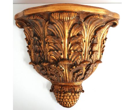 LARGE GILT WALL BRACKETof shaped outline supported by oak leaves and a pineapple finial, 54.5cm high 