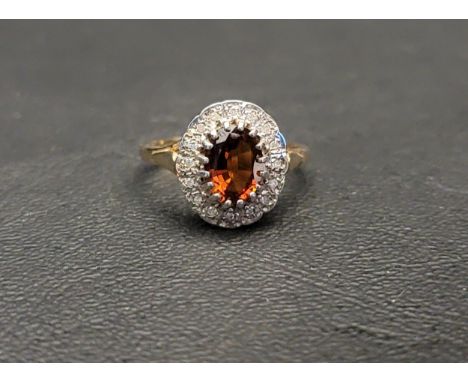 CITRINE AND DIAMOND CLUSTER RINGthe central oval cut citrine approximately 1ct in a sixteen diamond surround, on nine carat g