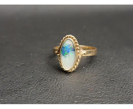 OPAL TRIPLET RINGthe oval opal triplet in rope twist surround, on nine carat gold shank, ring size M 