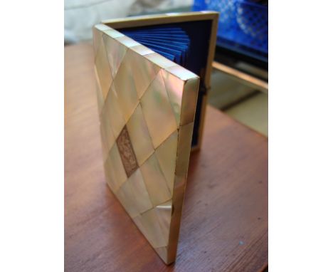 A mother of pearl card case with silver lozenge, slightly a/f.