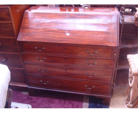 A George III mahogany fall front bureau, the sloped front enclosing a fitted interior with central cupboard and an arrangemen