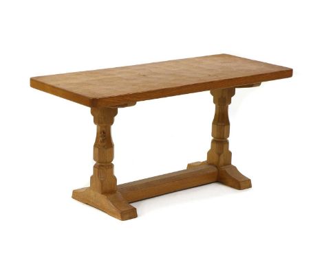 A Robert 'Mouseman' Thompson oak side table, the rectangular adzed top raised on turned octagonal supports, with the carved m