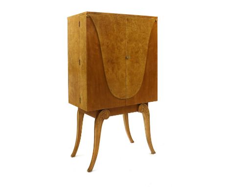 An Art Deco burr maple cocktail cabinet,by Hille, the cupboards mounted with 'U' shaped details, opening to reveal a mirrored