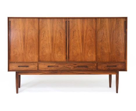 A Danish rosewood highboard, §1960s, designed by Kurt Østervig for Brande Møbelfabrik, the front with four sliding doors, eac