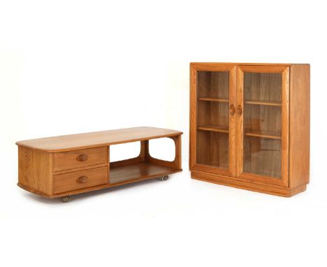 An Ercol elm 'Windsor Minerva' coffee table,with two drawers and a shelf, raised on castors,125cm wide53cm deep40cm high, and