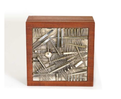 An Italian brutalist teak trinket box,c.1980, designed by Arnaldo Pomodoro, with an abstractly modelled silvered top, a prese