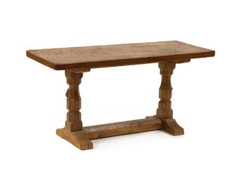 A Robert 'Mouseman' Thompson oak side table, the rectangular adzed top raised on turned octagonal supports, with the carved m