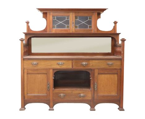 An Arts and Crafts mahogany mirror-backed sideboard,  the raised back centred with a leaded stained glass cupboard, shelves t