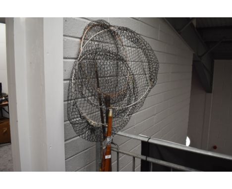 Four vintage fishing rods and three landing nets