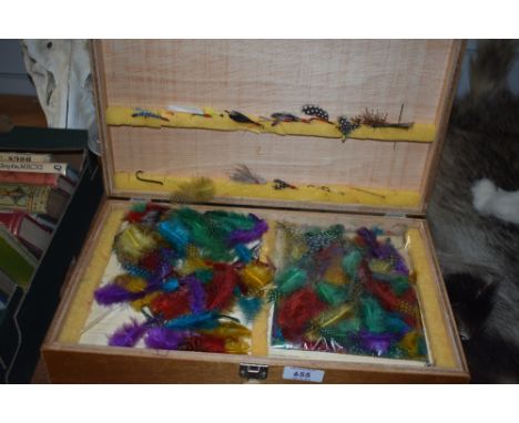 A three compartment wooden box containing Fly tying equipment with a selection of cotton selection of feathers and a large as