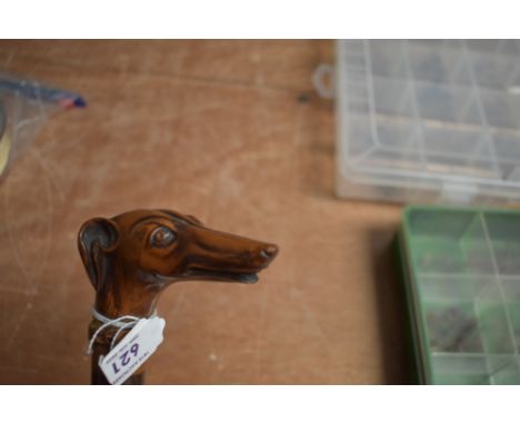 A vintage walking cane with a carved greyhound dogs head. It has been broken around the collar area and an average repair att