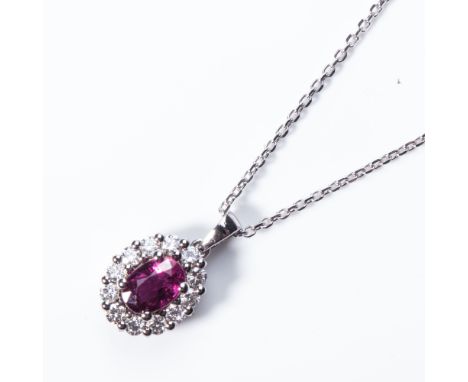 Claw-set to the centre with an oval brilliant-cut ruby, weighing approximately 5 carats, surrounded by pave-set diamonds, wit
