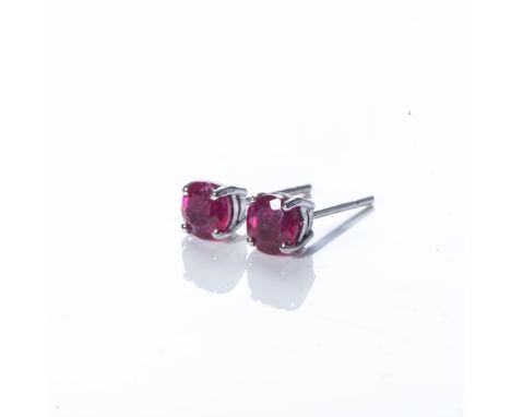 Each claw-set with a round brilliant-cut ruby, weighing 0,40 carats, with a combined weight of 0,80 carats, in a 9ct white go