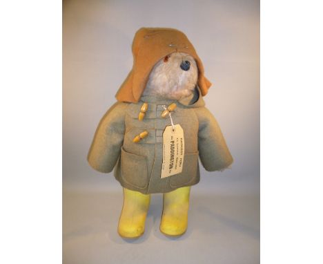 VINTAGE PADDINGTON BEAR WITH YELLOW DUNLOP BOOTS, LIGHT BROWN DUFFEL COAT, ORIGINAL LABEL (DESIGN REGISTRATION No. 957892) AN