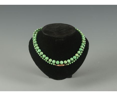 A light green graduated jade necklace with gold octagonal clasp total length 760mmThe absence of a condition statement does n