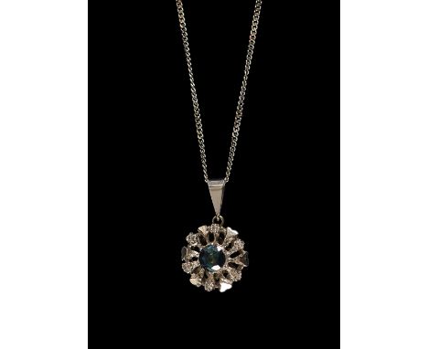 A 14 carat circular diamond and sapphire drop pendant, having 6 brilliant cut diamonds surrounding a central elevated single 
