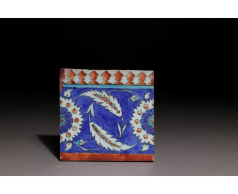 An Iznik pottery tile, Ottoman Turkey, circa 1575-1580Of rectangular form, the dense cobalt-blue ground with two curling sazl