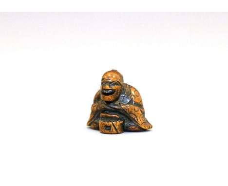A wood Netsuke of a man with a grain mill, by GyokuzanJapan, Edo period (1603-1868) 18th/19th centuryCarved in a seated posit