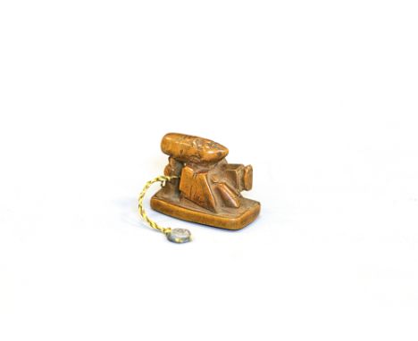 A wood netsuke of FukurokujuJapan, Edo period (1603-1868) 18th/19th centuryCarved on a base, holding a fan in his left hand, 