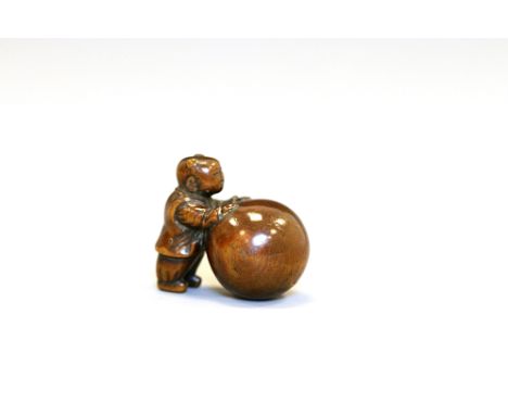 A wood netsuke of a KarakoJapan, Edo period (1603-1868)Finely carved standing, pushing a large ball.Height 4.3 cm.Some wear a