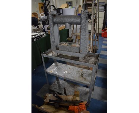 A Galvanized Three Tier Plant Shelf and a Paraffin Heater 