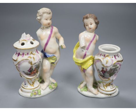 A pair of 18th century Meissen figures of putti and vases, height 14cmCONDITION: Youth wearing yellow robe both arms lacking;