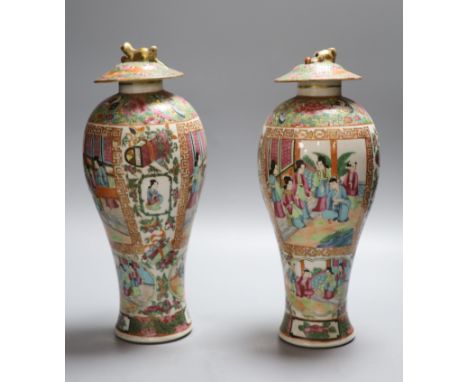 A pair of 19th century Chinese famille rose vases and associated covers, height excl. cover 28cm (a.f.)CONDITION: One vase br