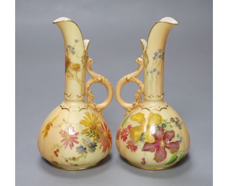 A pair of Royal Worcester blush ivory ewers painted and gilded with flowers, green mark, date code 1900, height 15cm